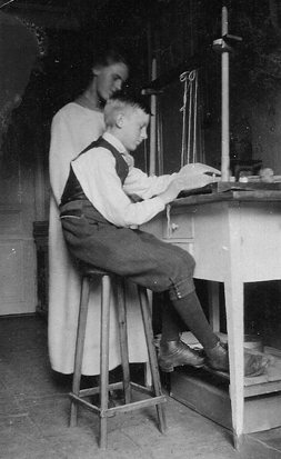 Photo of Hellen Collden teaching her brother, Daniel, bookbinding, circa 1919
